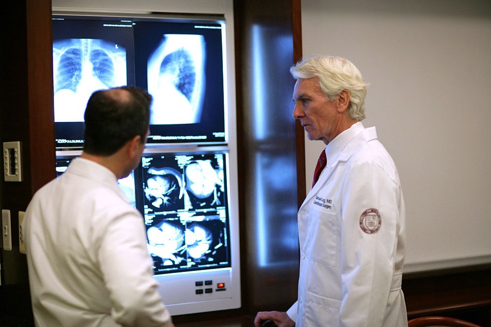 Surgeons look at x-rays to identify cardiac tumors.