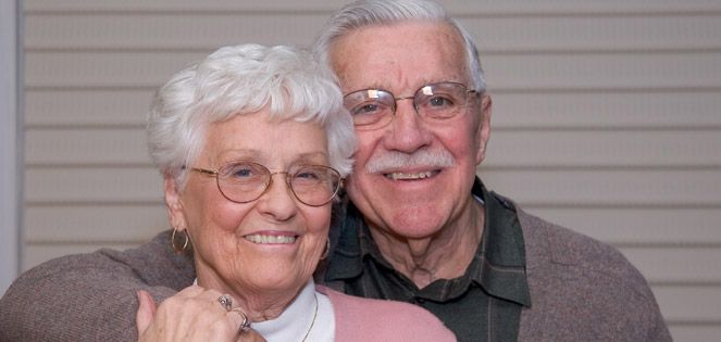 Older couple embracing.